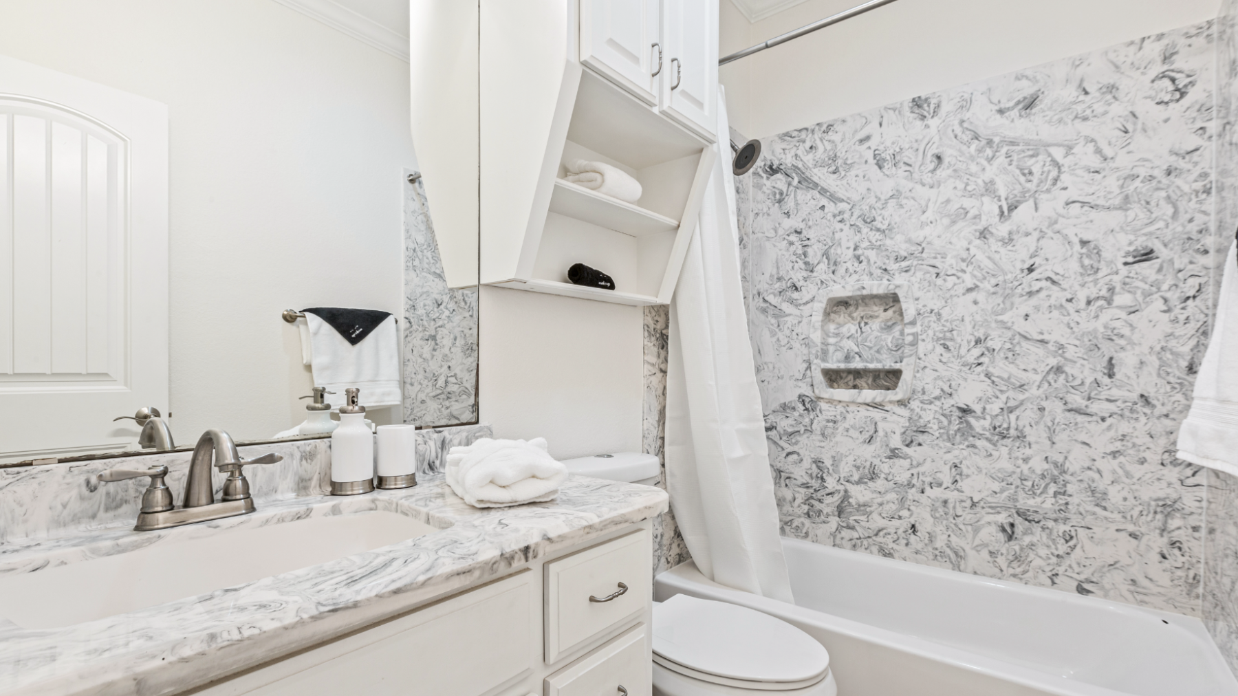 a room with a sink and a mirror